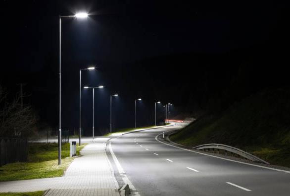 A road with a lot of street lights on it at night.