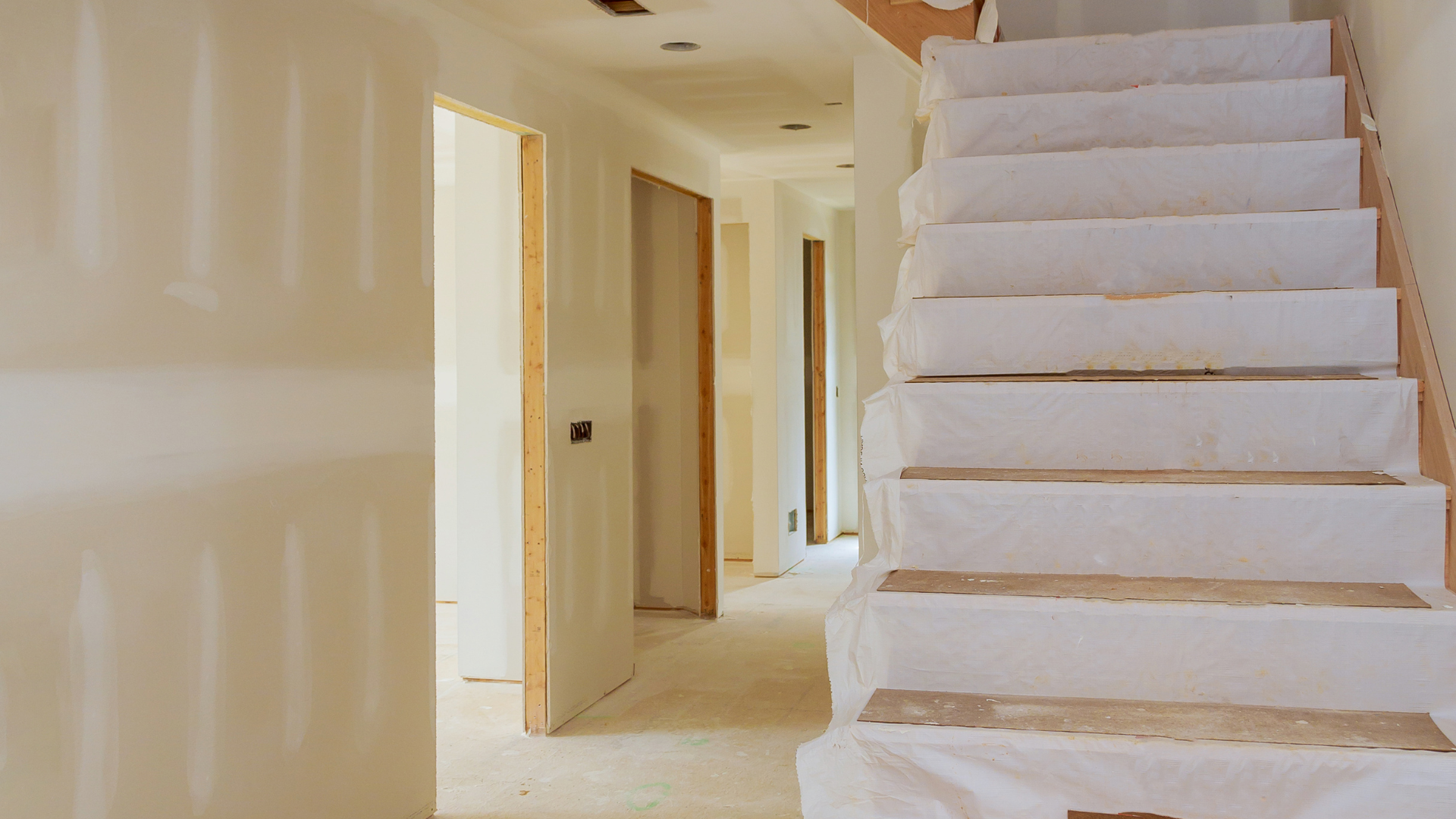 a kitchen with empty cabinets and counter tops is being remodeled .