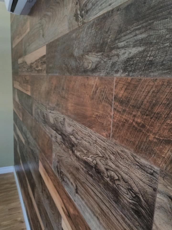 An accent wall featuring horizontal planks of rustic, weathered wood in varying tones of brown and grey.