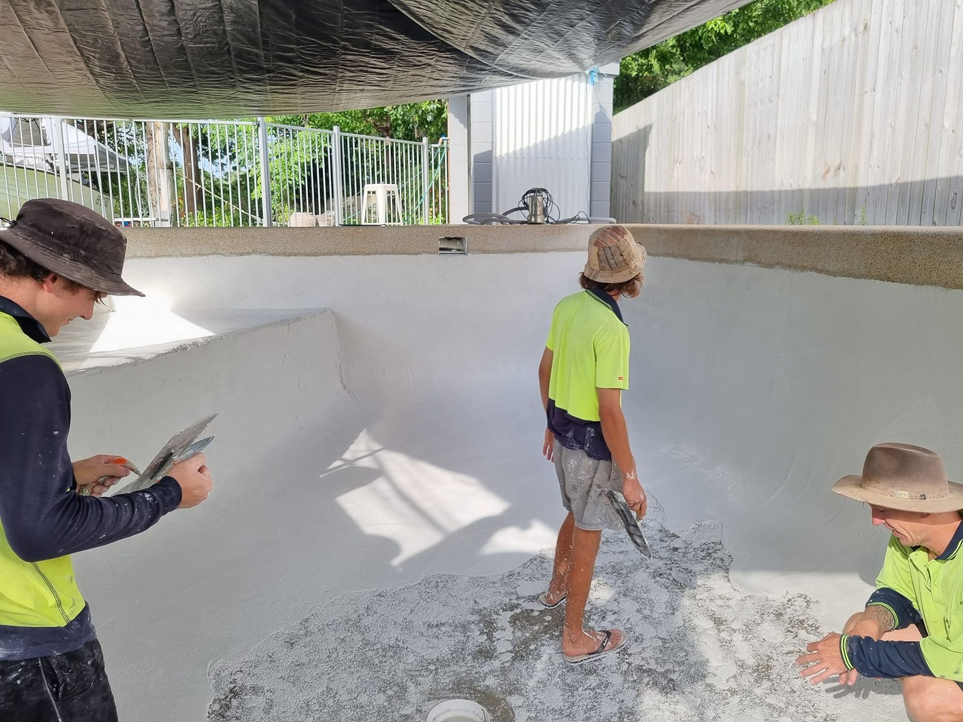 Worker Finishing Pool Floor — Gulliver, QLD — Concrete Pool Repairs