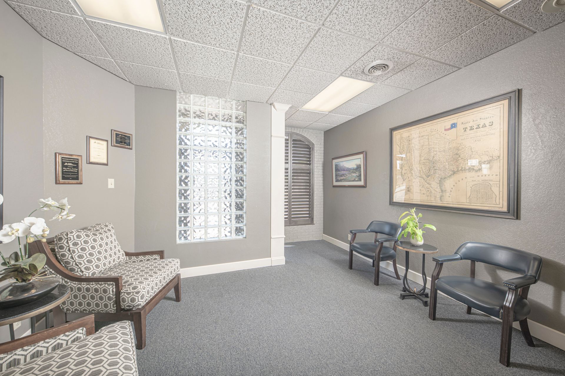 A waiting room with chairs , tables and a large map on the wall.