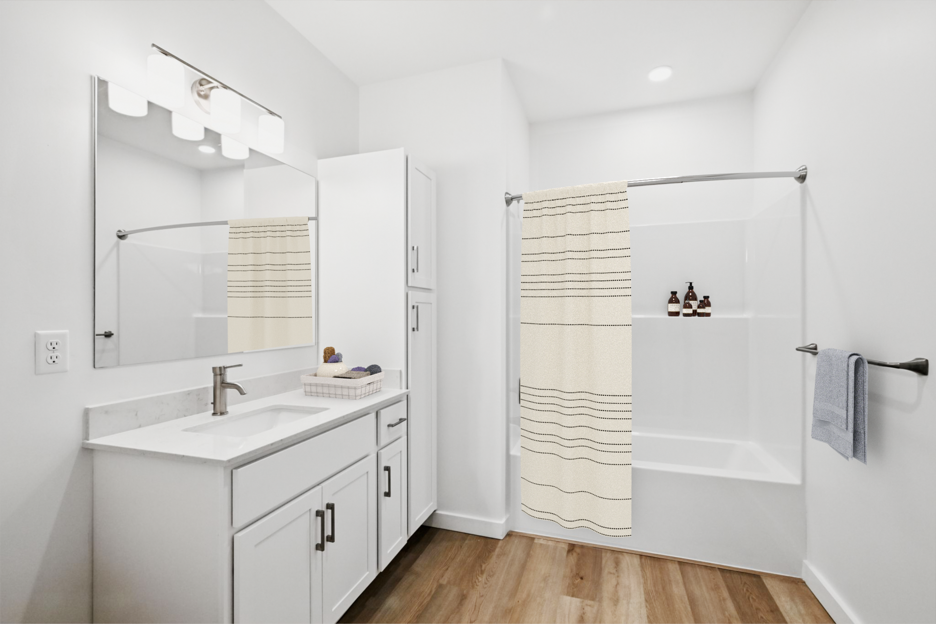 White bathroom with vanity, storage cabinet, bathtub, and wood-look floor.