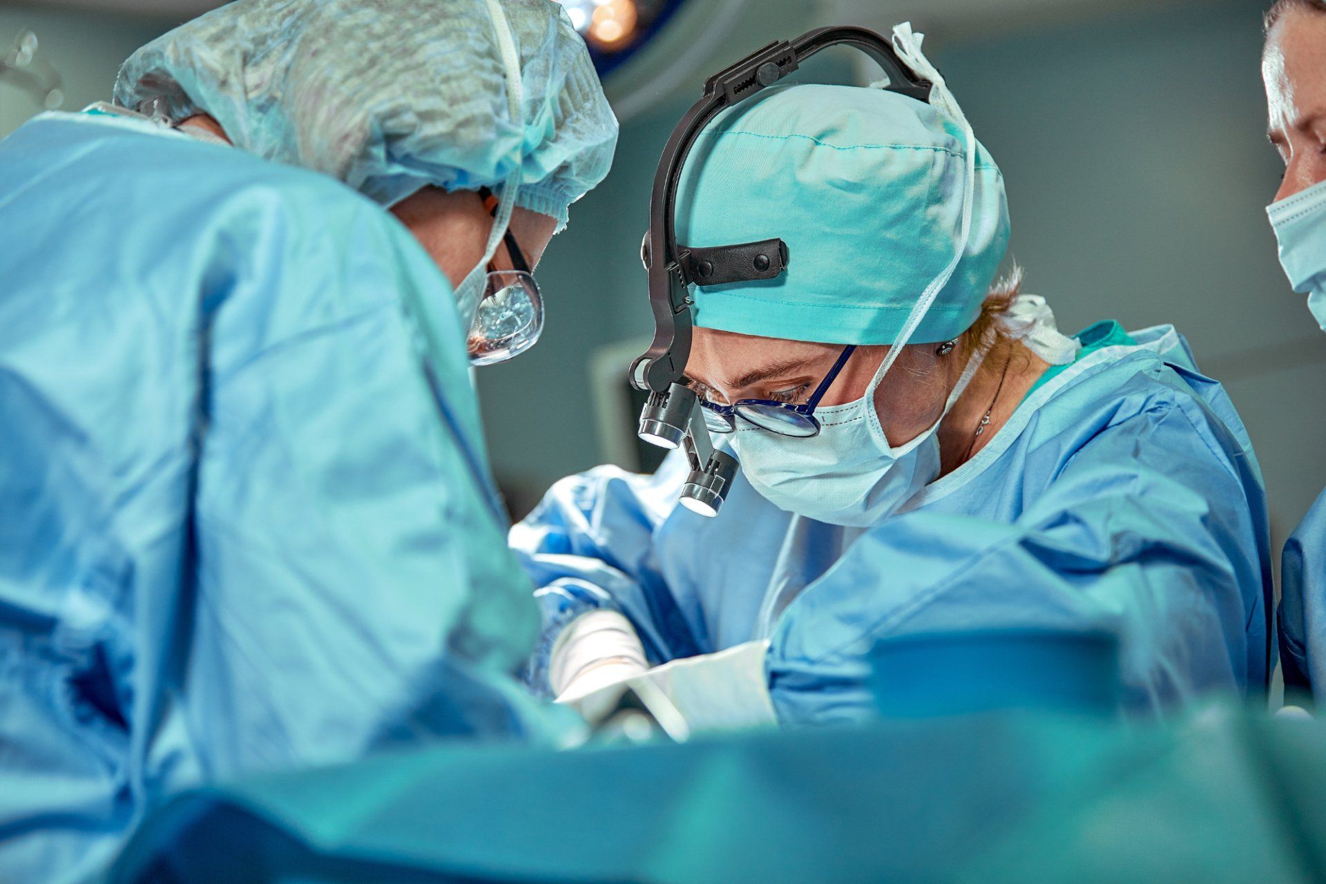 female surgeon operating on patient