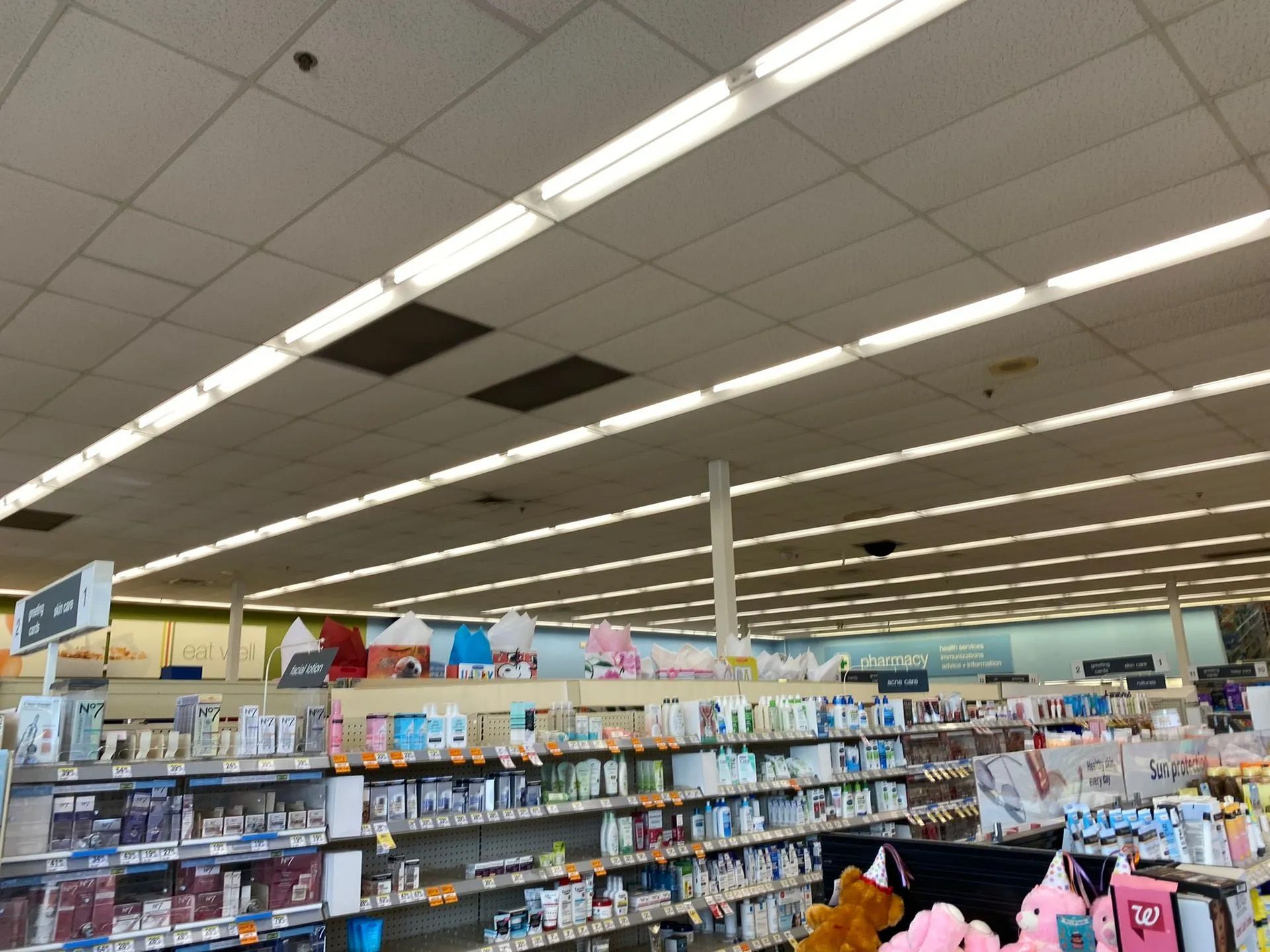 The inside of a pharmacy with lots of shelves and lights