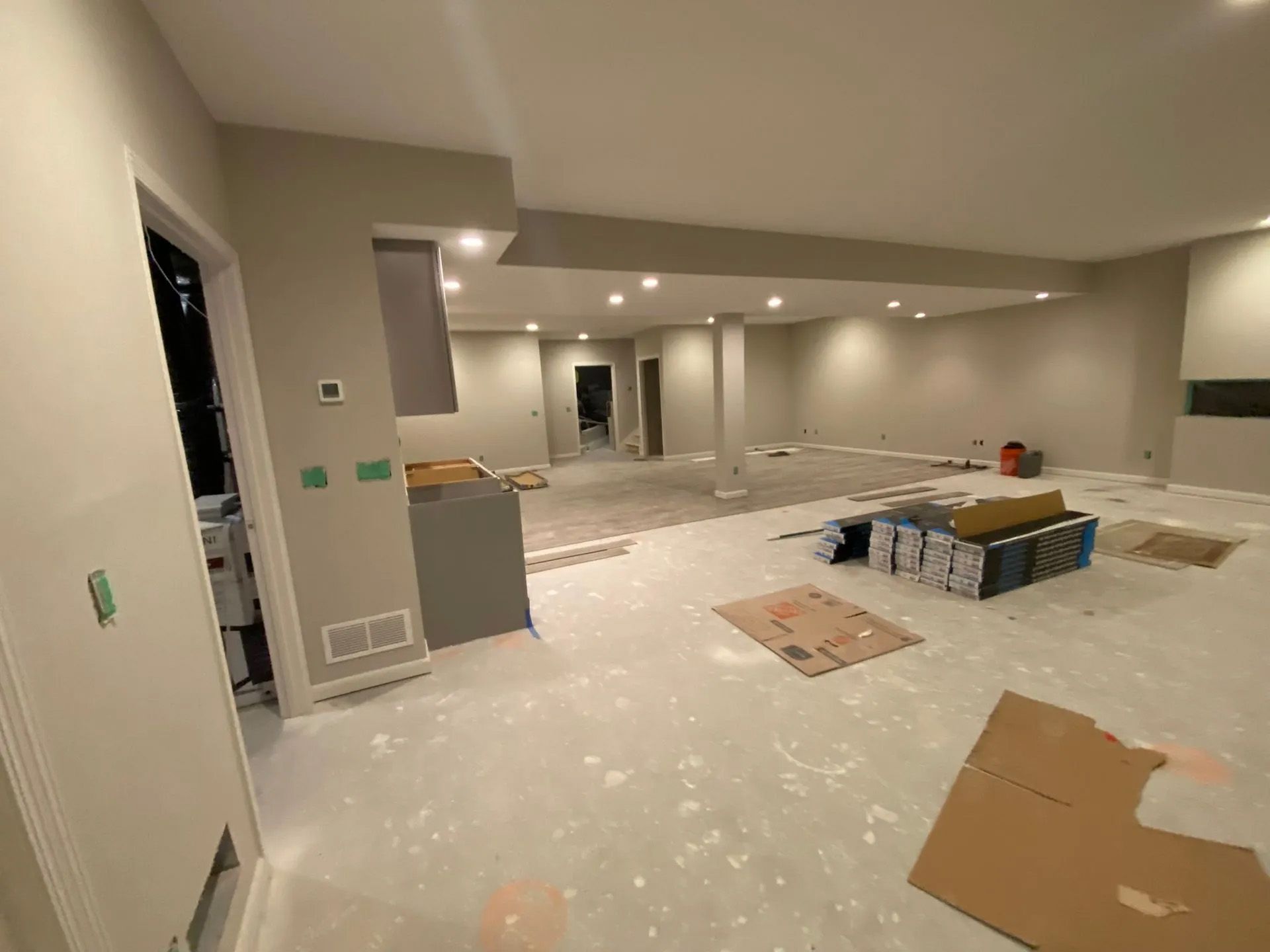 A large empty room with a lot of boxes on the floor.