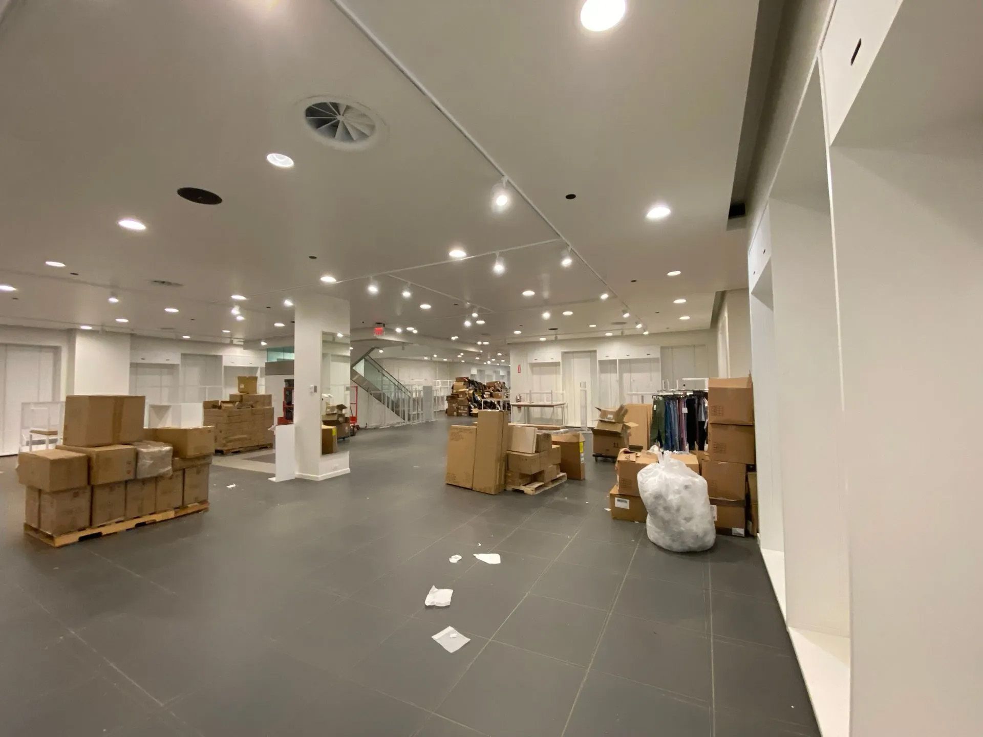 A large empty room with a lot of boxes on the floor.