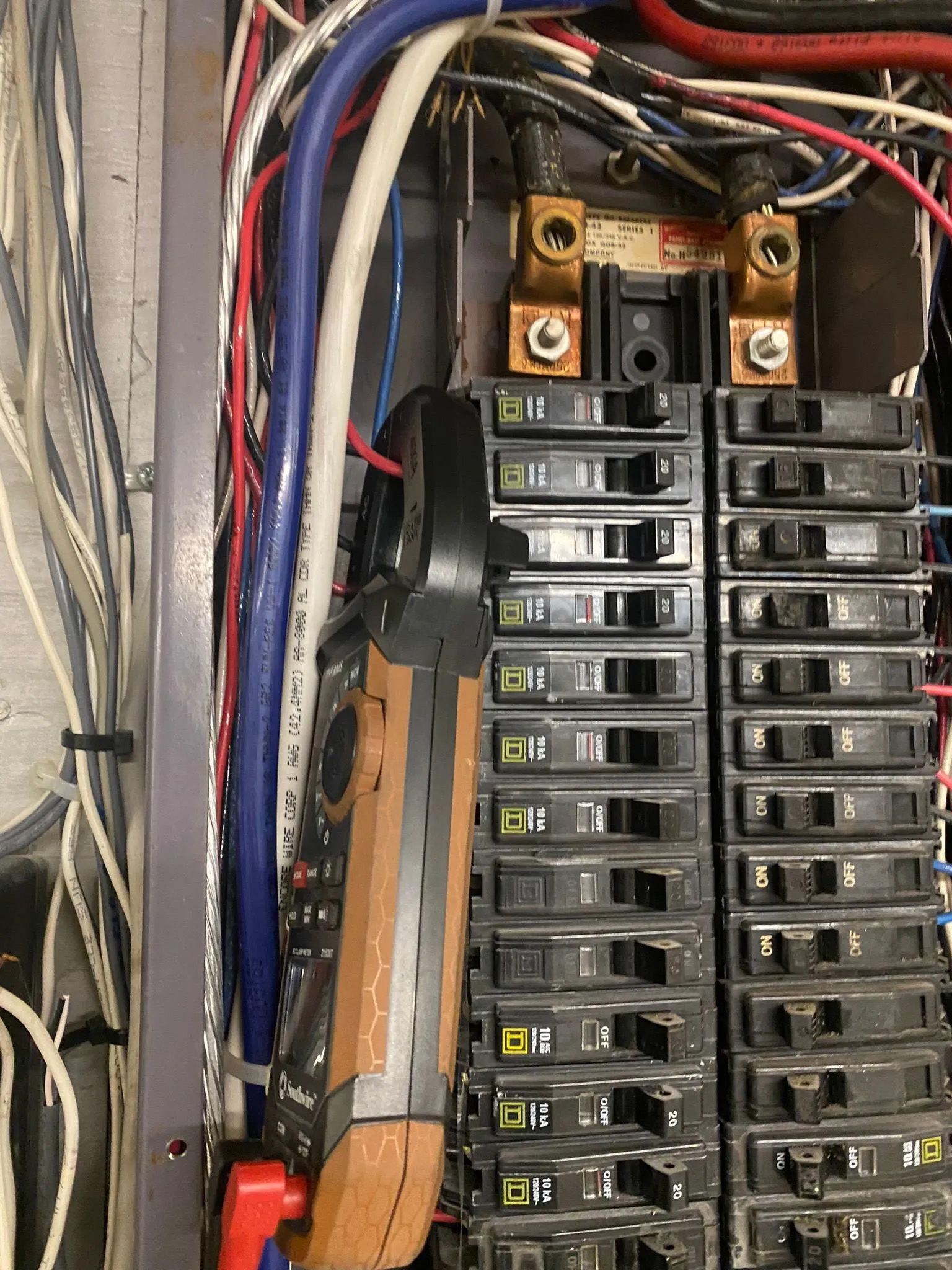 A close up of a electrical panel with a multimeter in it