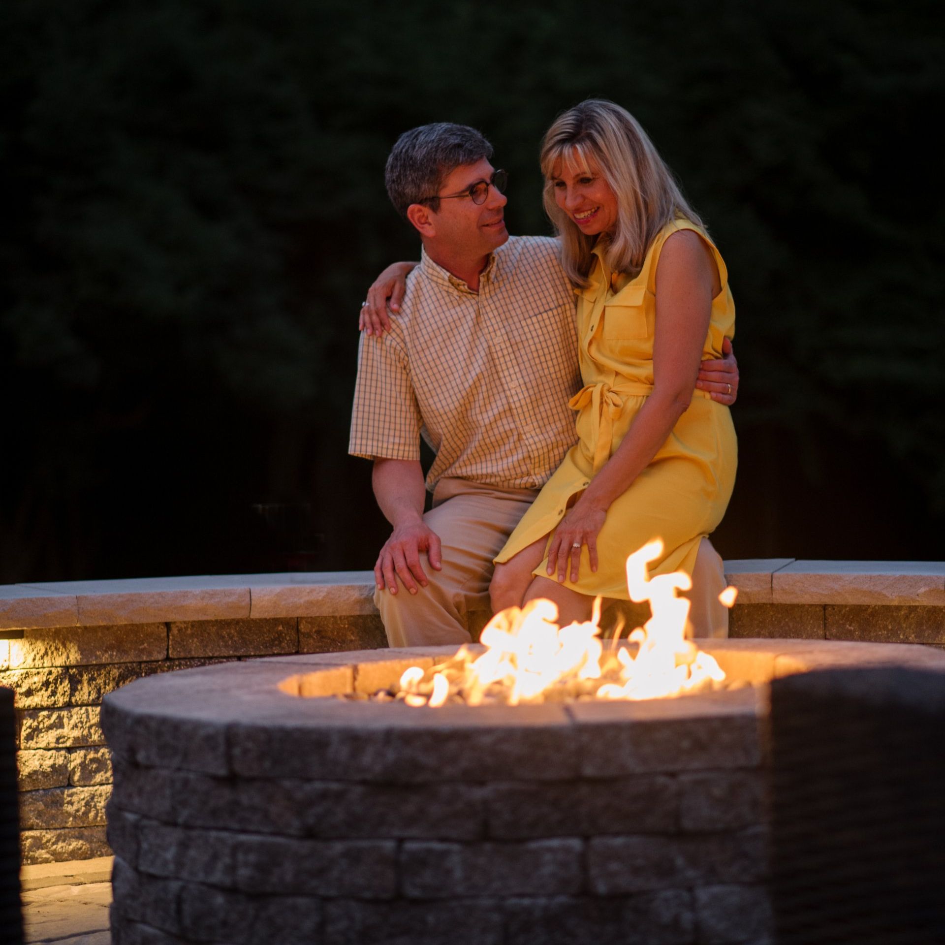 A couple sitting by a fire pit — St. Louis, MO — Fireplace and Grill Center