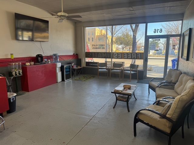 A waiting room with a couch and chairs and a sign that says ara