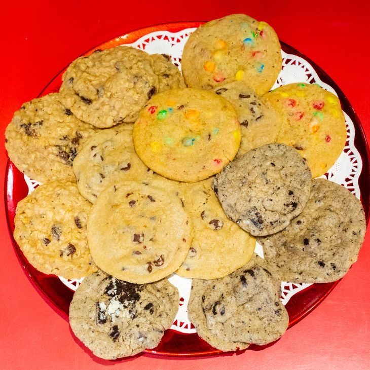 A plate of different types of cookies on a red background