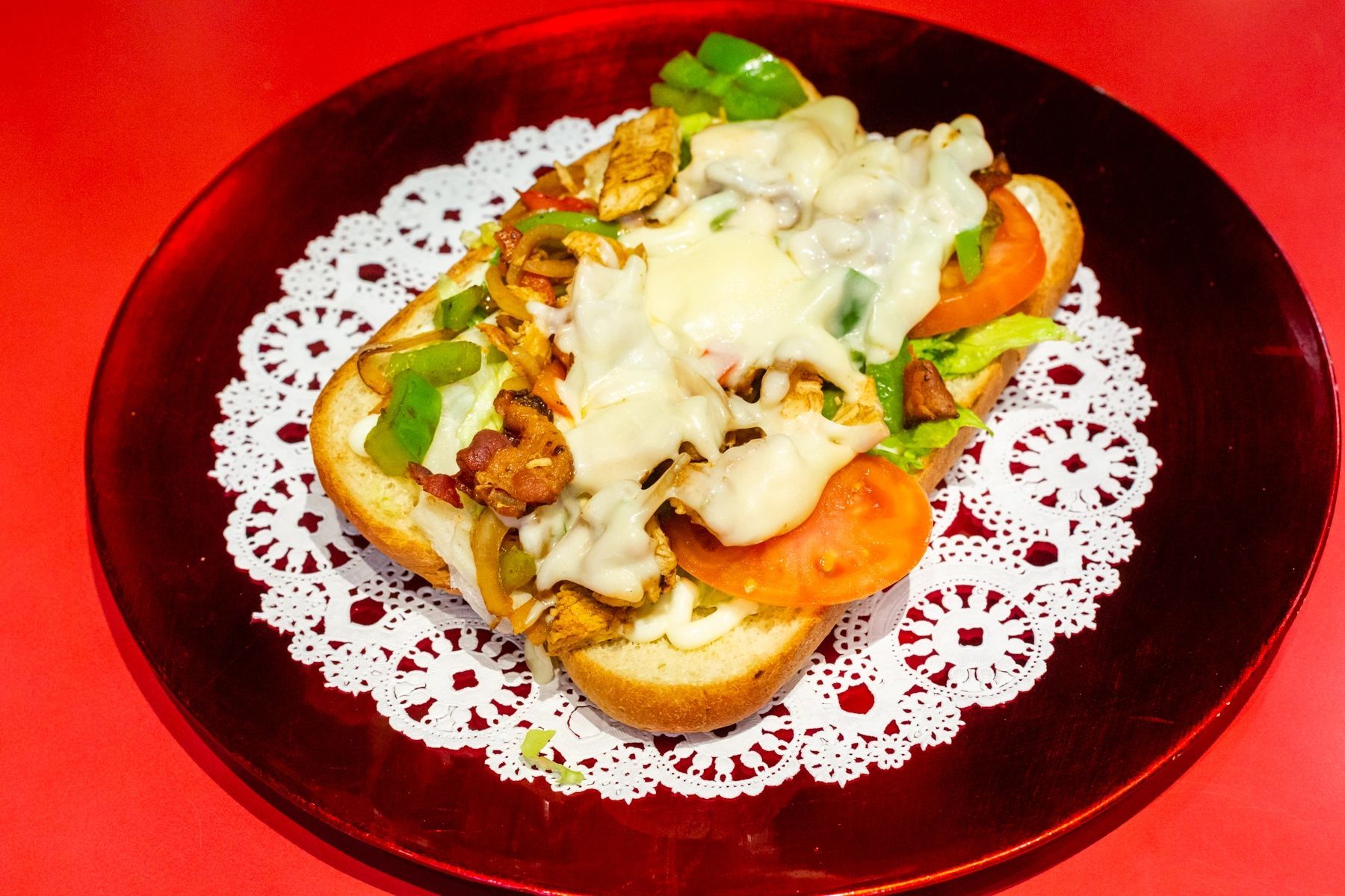 A sandwich on a plate with lace on it