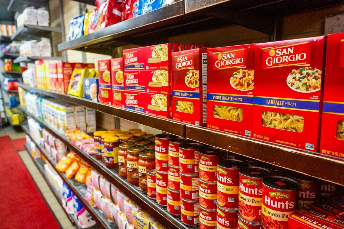 A grocery store aisle filled with lots of canned food.