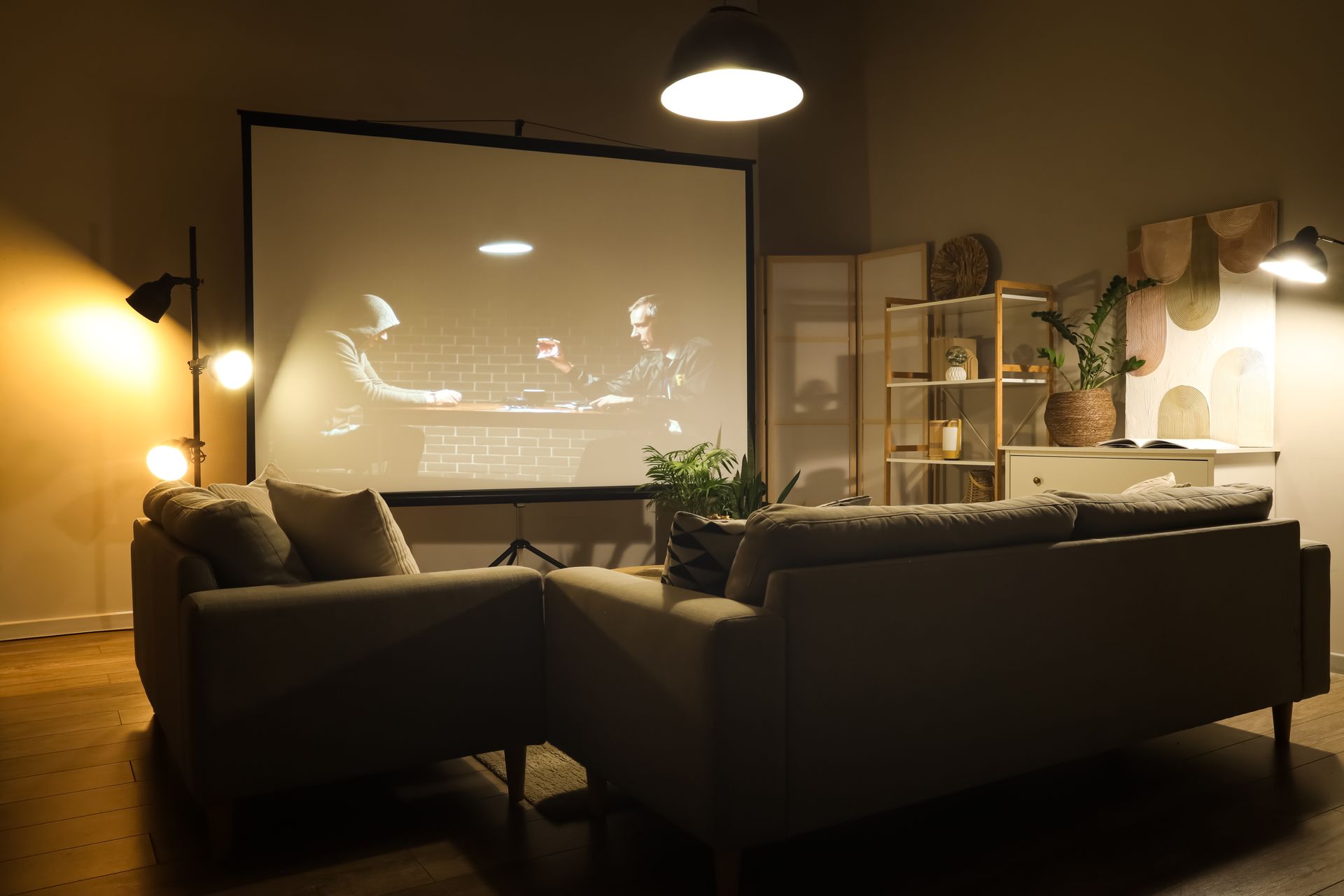 Person painting siding on a house from a ladder; blue sky in background.