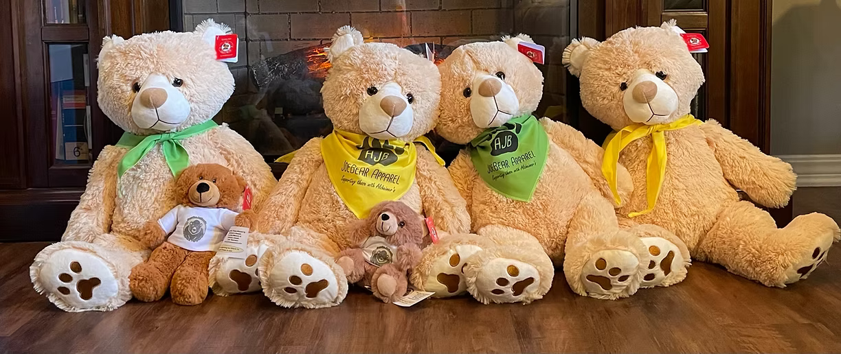 A group of teddy bears are sitting next to each other on a wooden table.