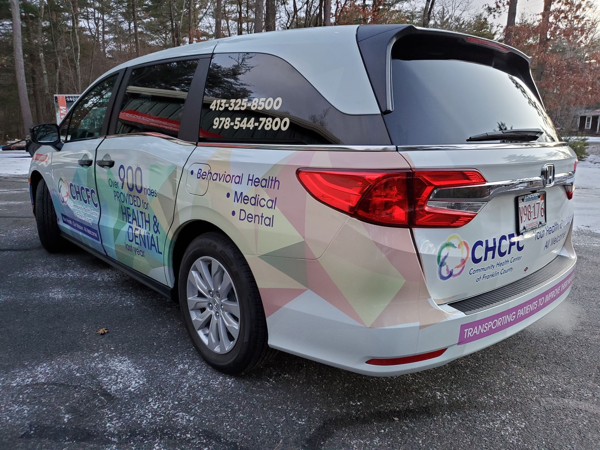 White minivan with CHCRC logo and phone numbers parked outdoors.