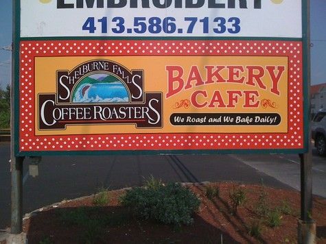Sign for Shelburne Falls Coffee Roasters Bakery Cafe. Brown, red, and yellow design.