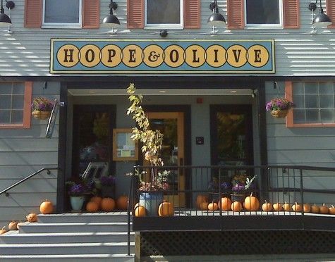Hope & Olive restaurant entrance with pumpkins, autumn decor.