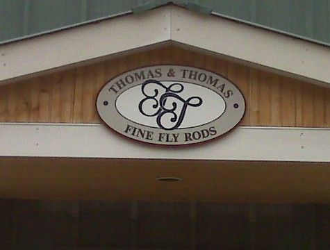 Sign for Thomas & Thomas Fine Fly Rods: oval, blue & white, with stylized 