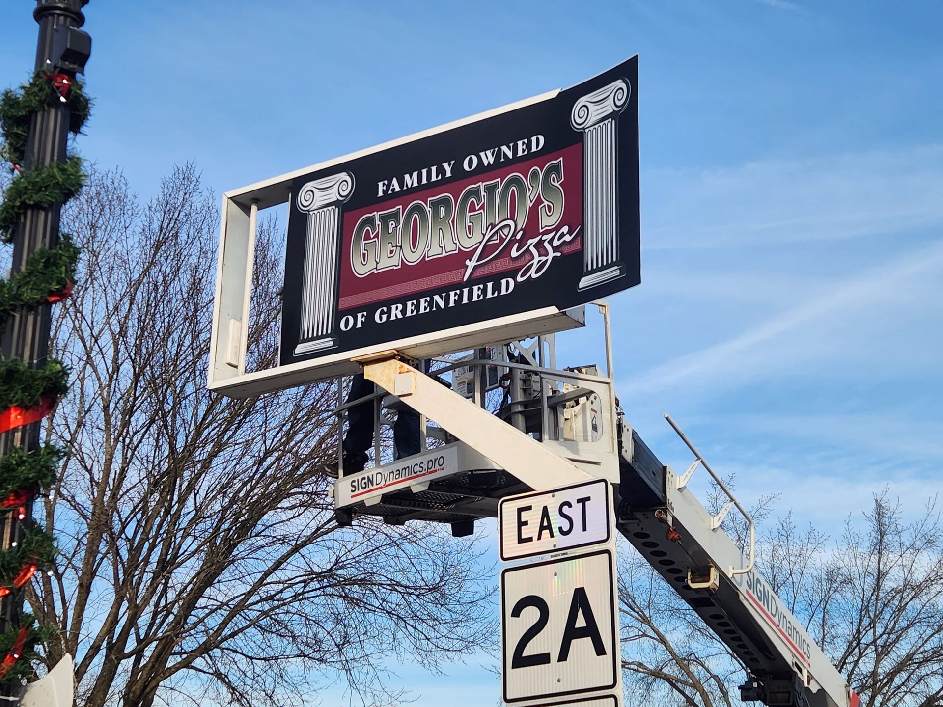 Black sign on brick building reads 