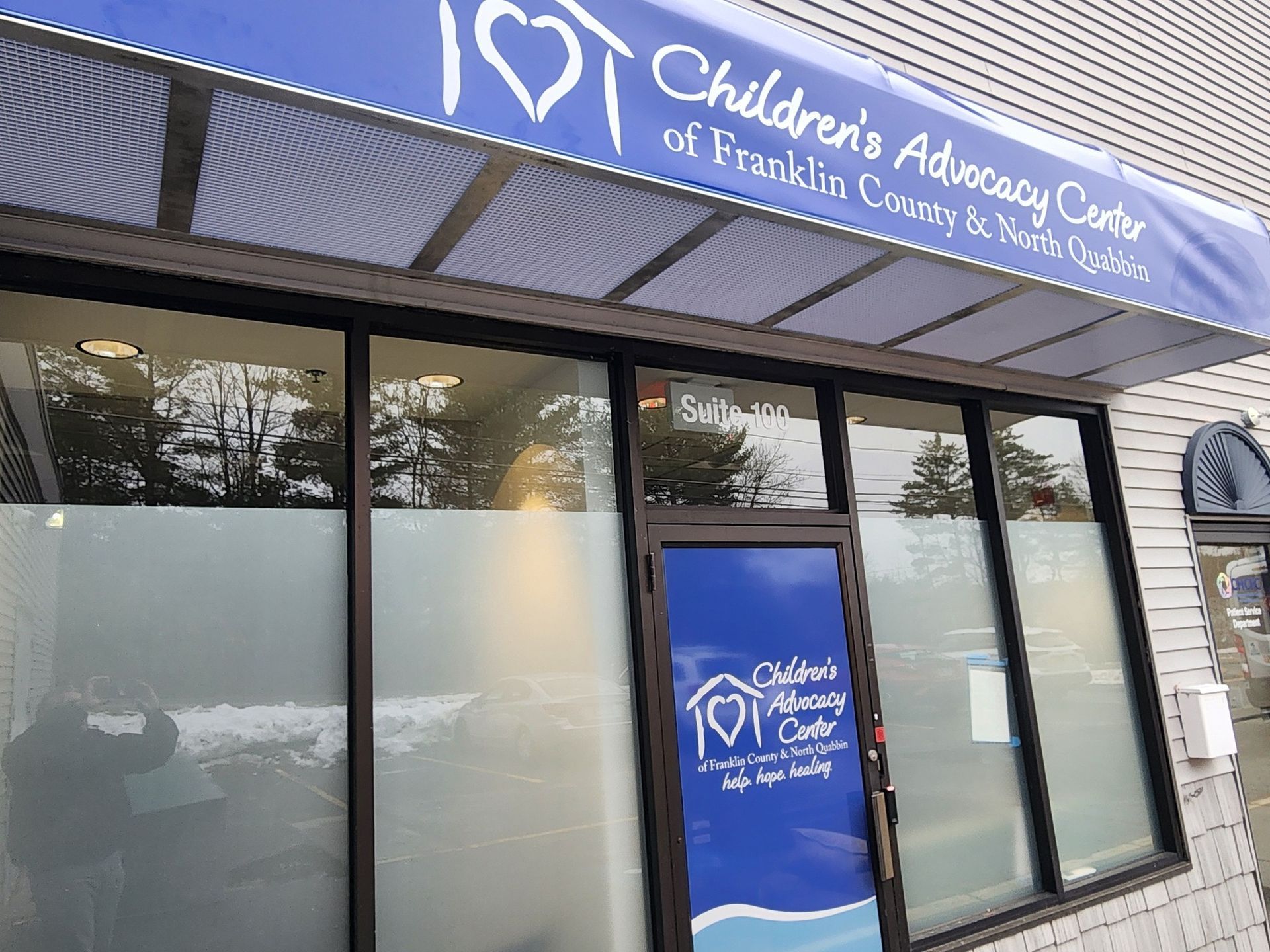 Children's Advocacy Center in Franklin County. Blue awning, glass door, frosted window, snow visible.