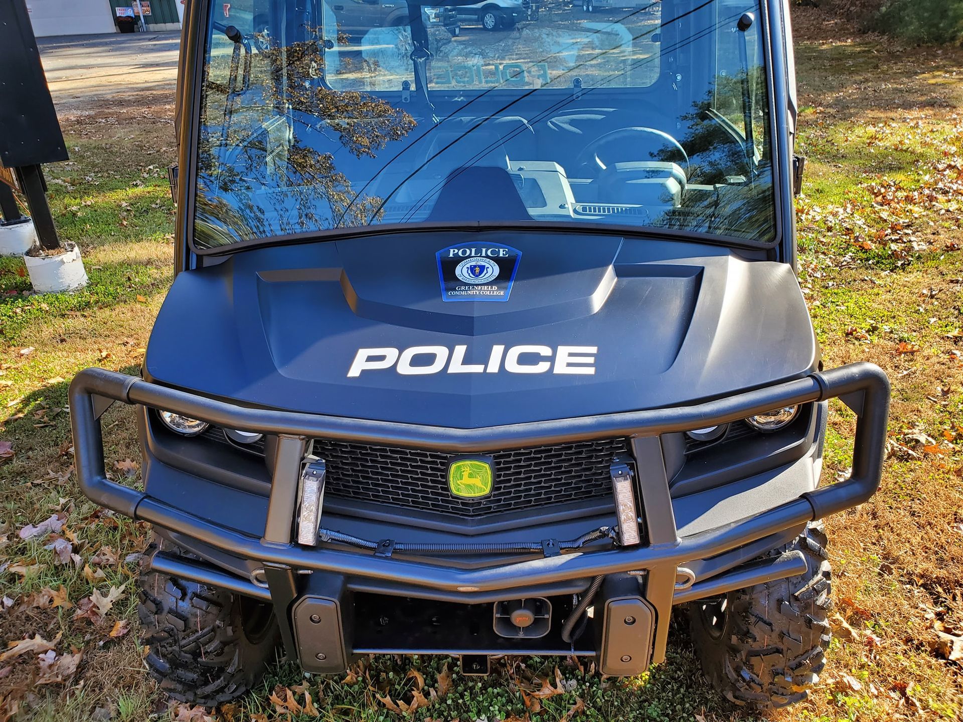 Dark blue police utility vehicle parked outdoors. 