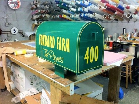 Green mailbox with yellow lettering