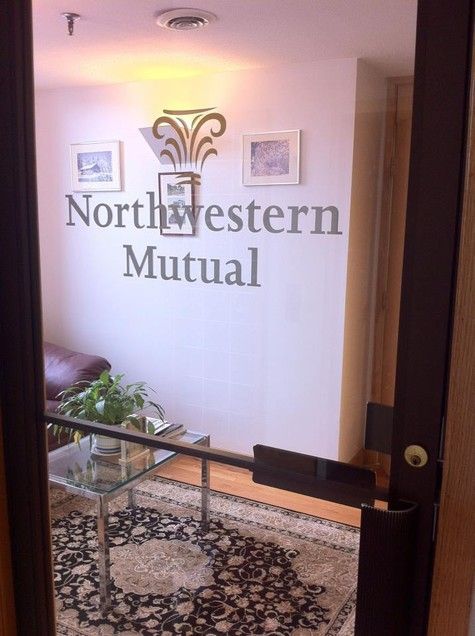 Northwestern Mutual office door with logo, small waiting area, black door frame.