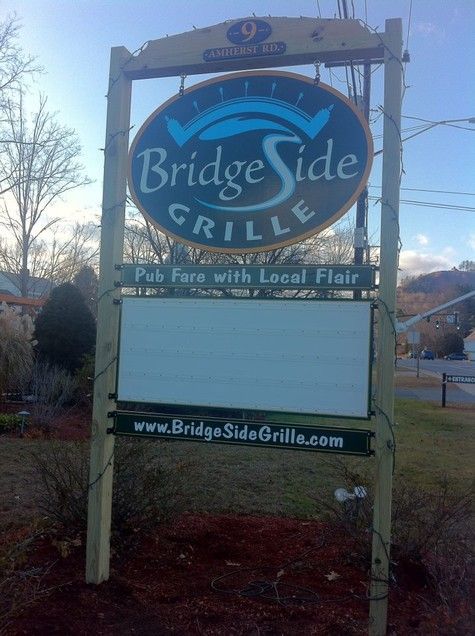 Sign for BridgeSide Grille: oval logo, 
