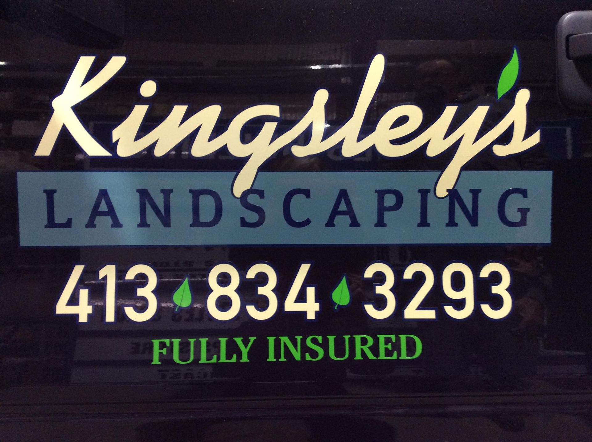 Kingsley's Landscaping sign with gold lettering, green accents. Phone number is 413-834-3293.  