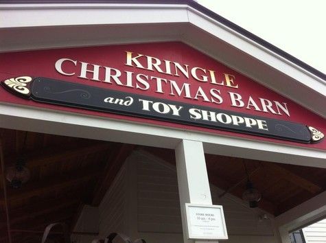 Kringle Christmas Barn and Toy Shoppe sign; gold lettering on a red background.