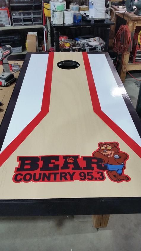 Cornhole board with Bear Country 95.3 logo; red, white, black design.