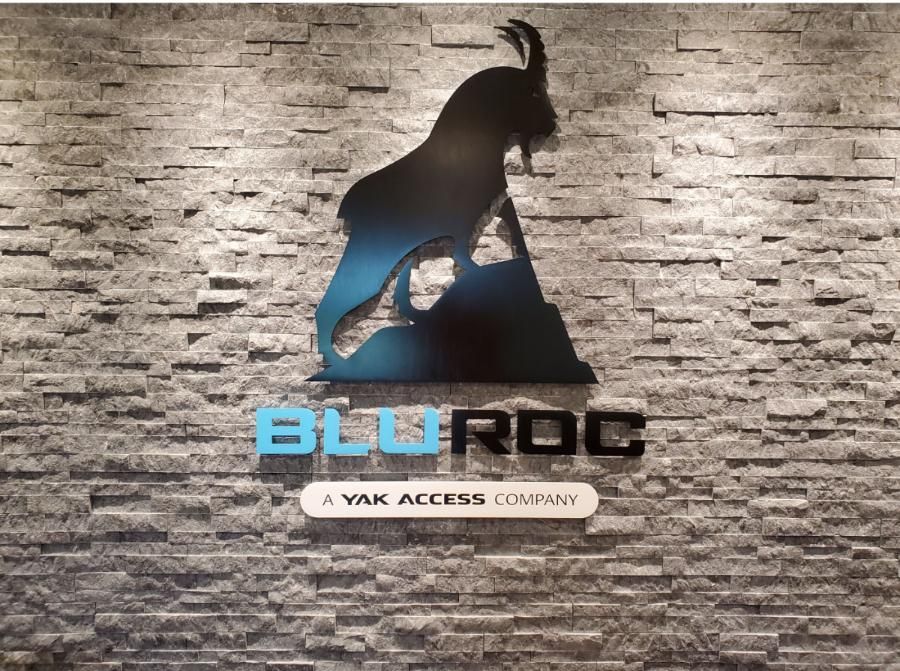BluRoc logo: silhouette of a goat on a rock, blue and black, above the blue company name, on a stone wall.