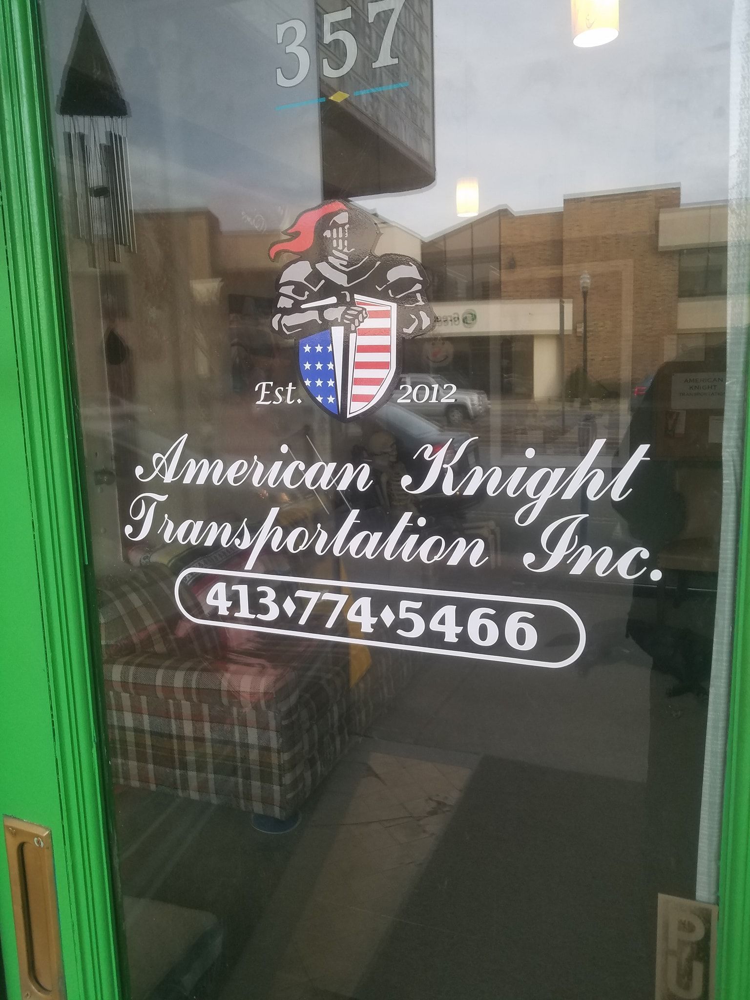 American Knight Transportation Inc. door with logo and phone number