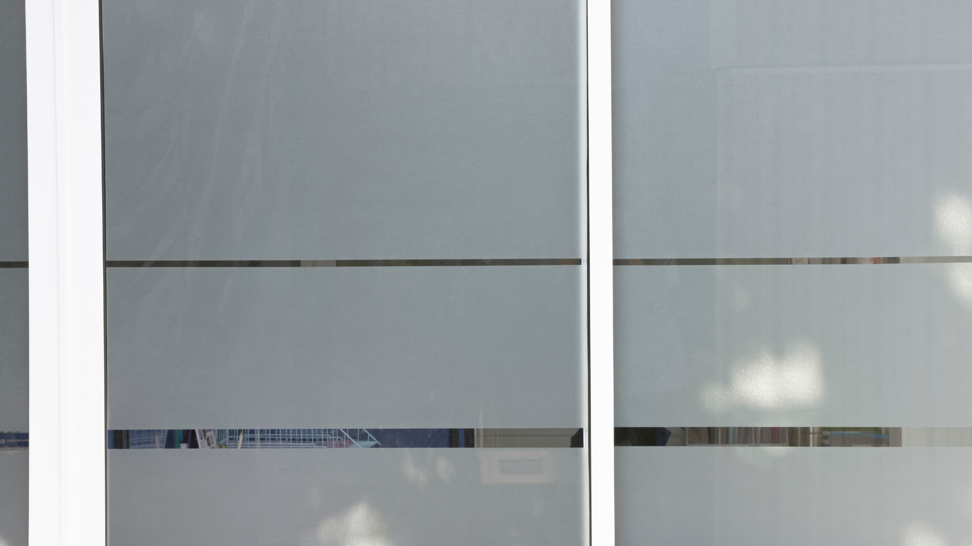 Frosted glass window panels with horizontal stripes and white frames.