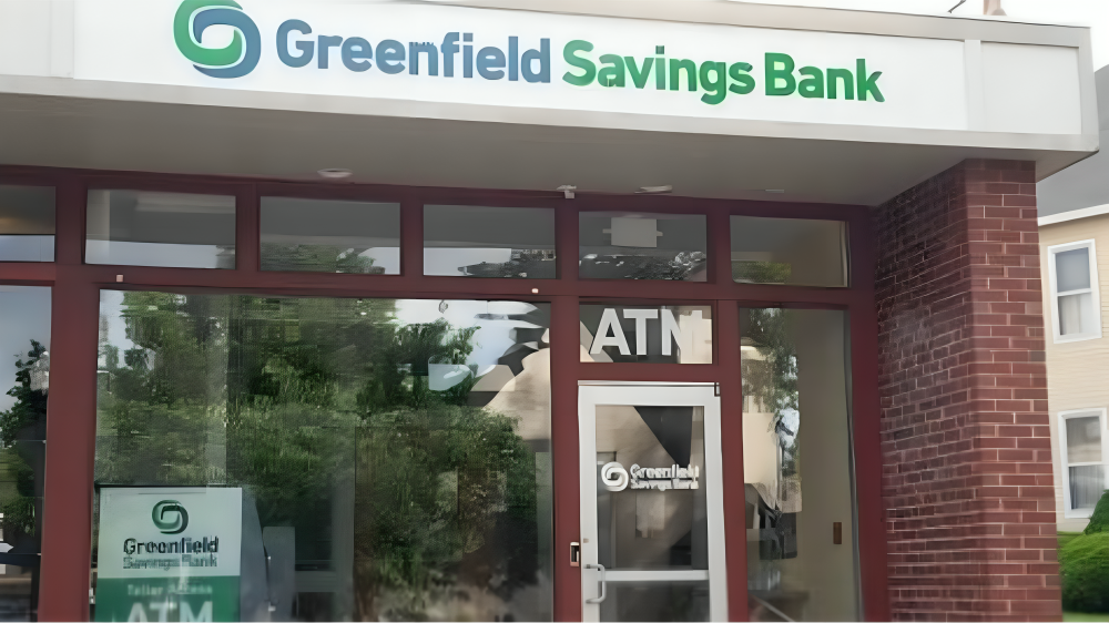 Greenfield Savings Bank exterior with red brick accents, ATM, and large windows.