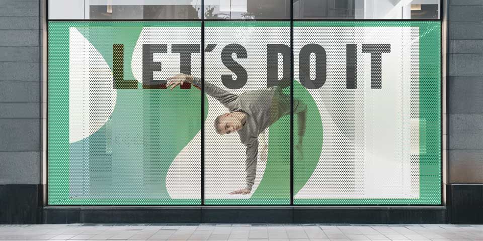 Man doing a handstand in a window with the words 