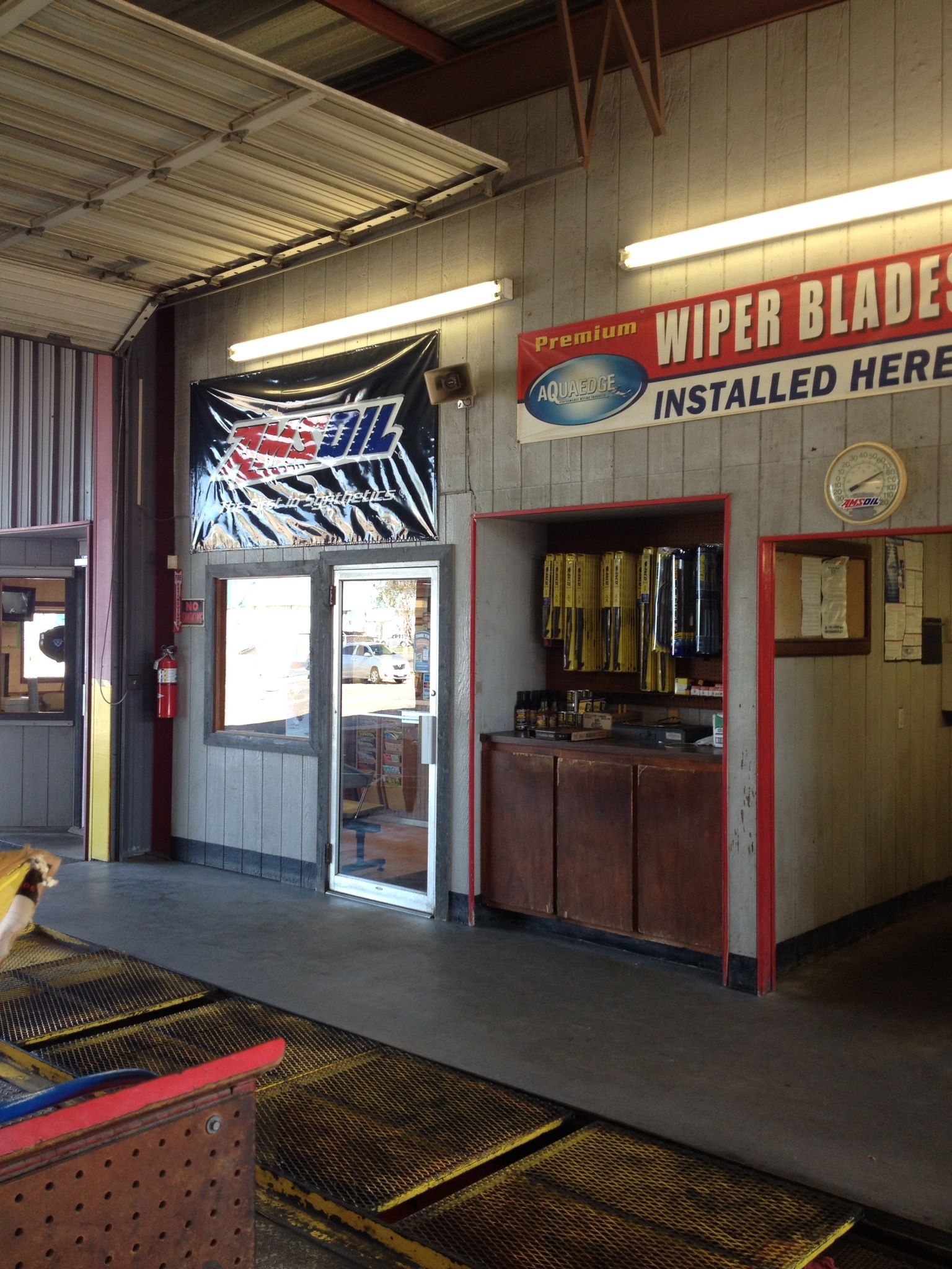 The inside of a garage with a sign that says wiper blades installed here