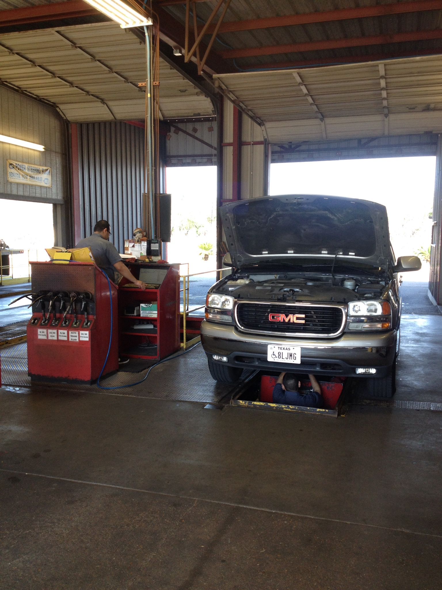 A gmc truck is being worked on in a garage