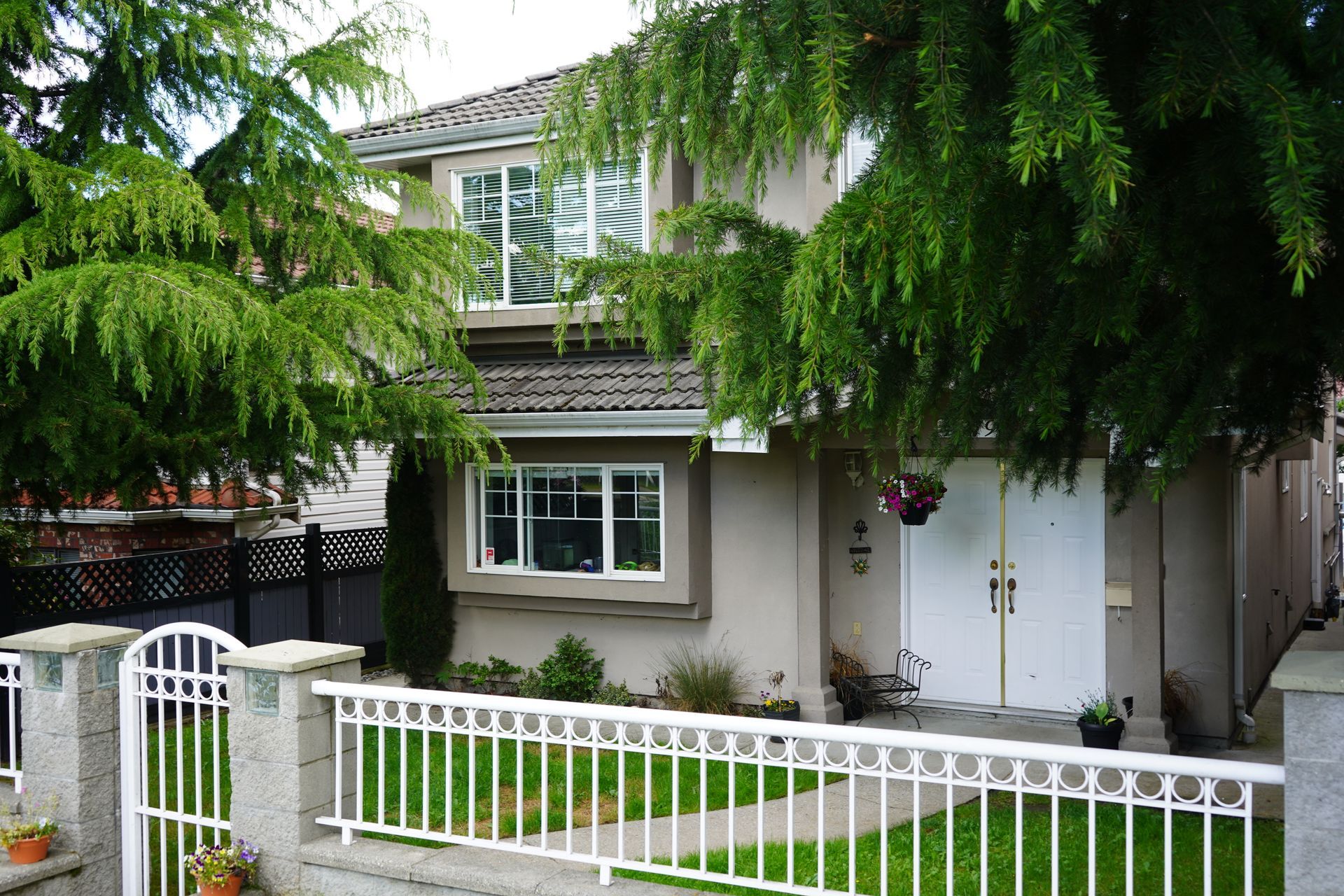 A house with a white fence in front of it