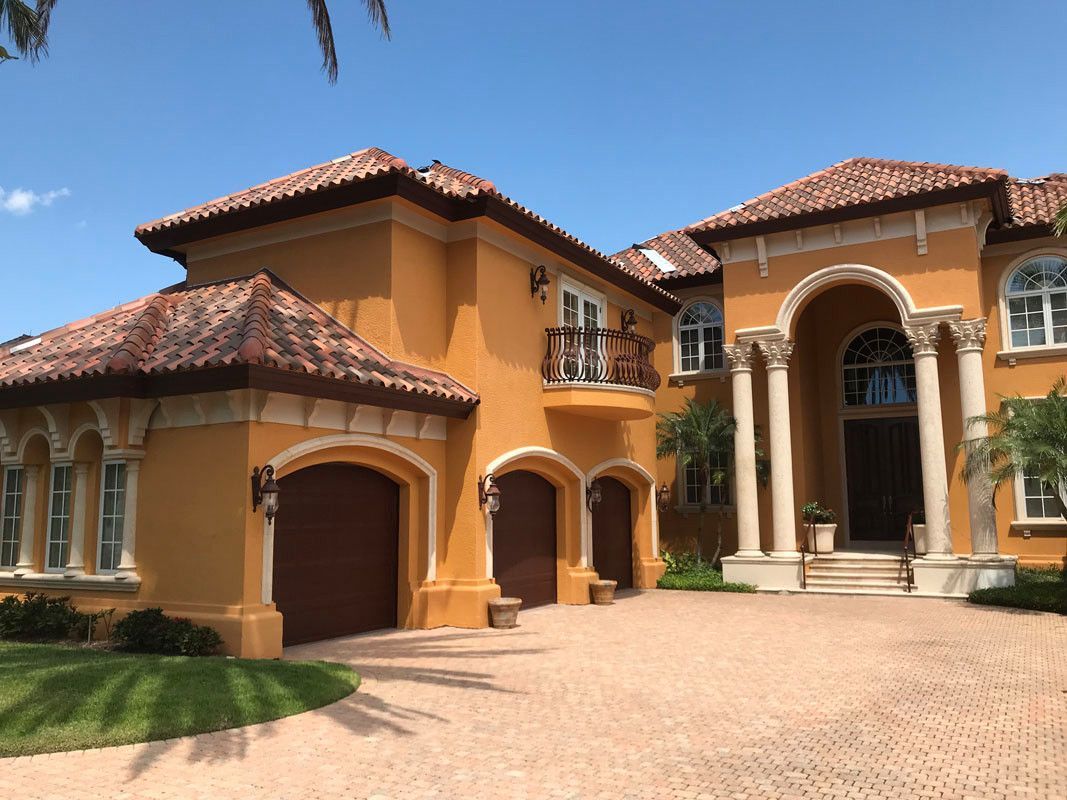 A large house with a lot of windows and a driveway