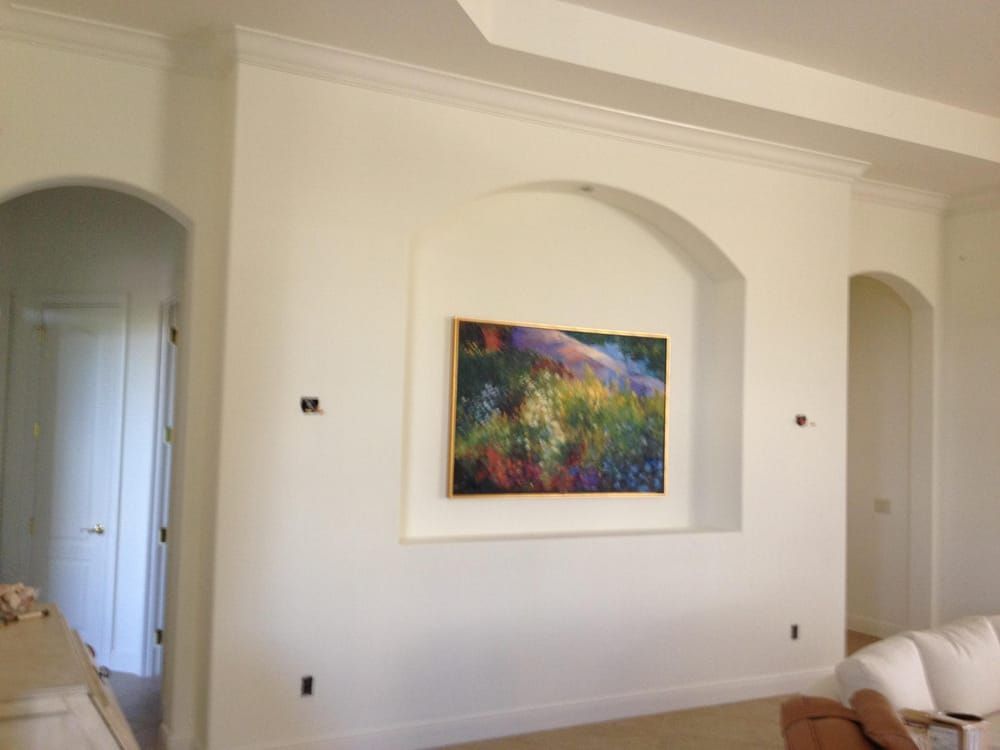 A living room with a painting on the wall