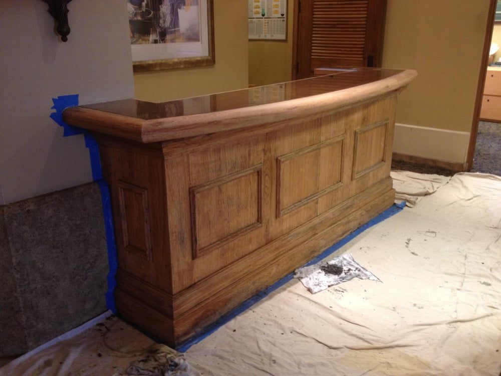 A wooden bar is sitting on a white cloth on the floor.