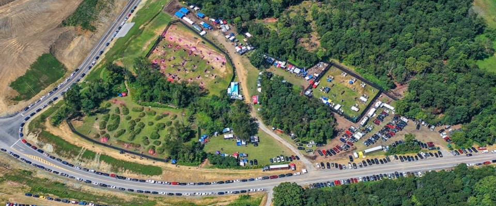 A group of boys are posing for a picture in front of a trailer that says rental and supply