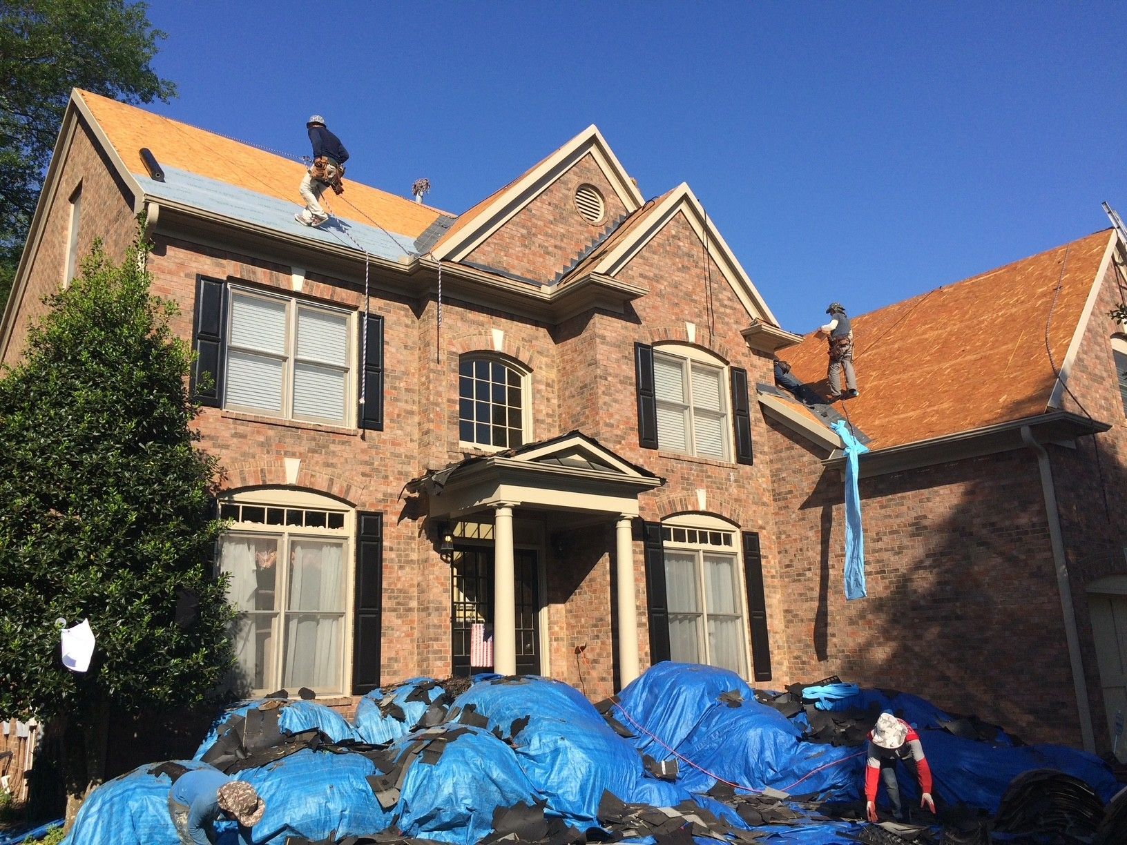 Roofing workers working on a roof