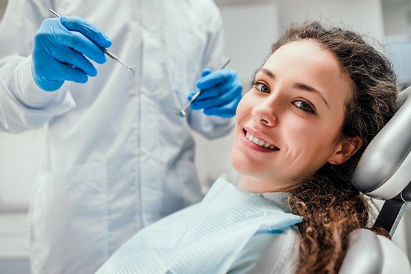 Smiling Young Woman Receiving Dental Checkup — McAllen, TX — Dr. Joey Cazares & Associates