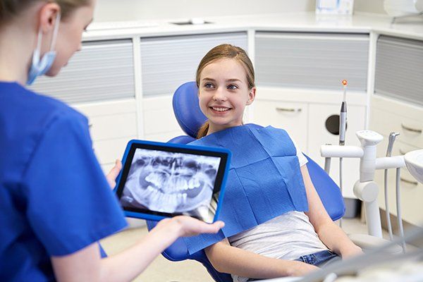 Dentist with X-Ray on Tablet and Patient Girl — McAllen, TX — Dr. Joey Cazares & Associates