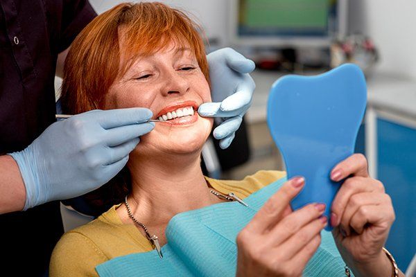 Smiling Senior Woman with New Dental Implants — McAllen, TX — Dr. Joey Cazares & Associates