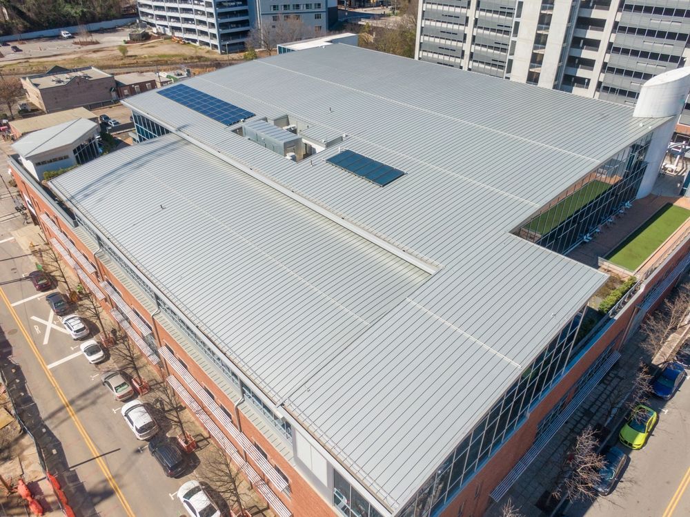 An aerial view of a large building with a metal roof.