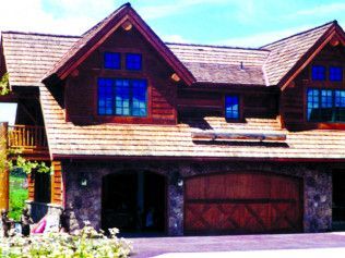 A large house with a large wooden garage door