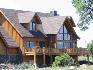 A large house with a lot of windows and a large deck
